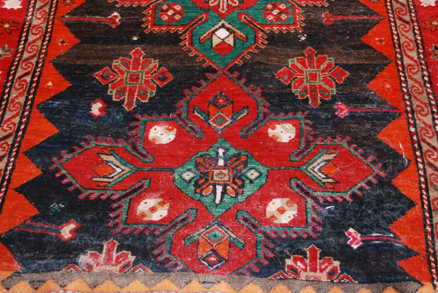 Afghan Belouch hand-knotted rug decorated with two large geometric motifs to the centre, on a red - Image 3 of 5