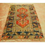 Turkish Dosemealti hand-knotted rug decorated with three central geometric medallions on a red