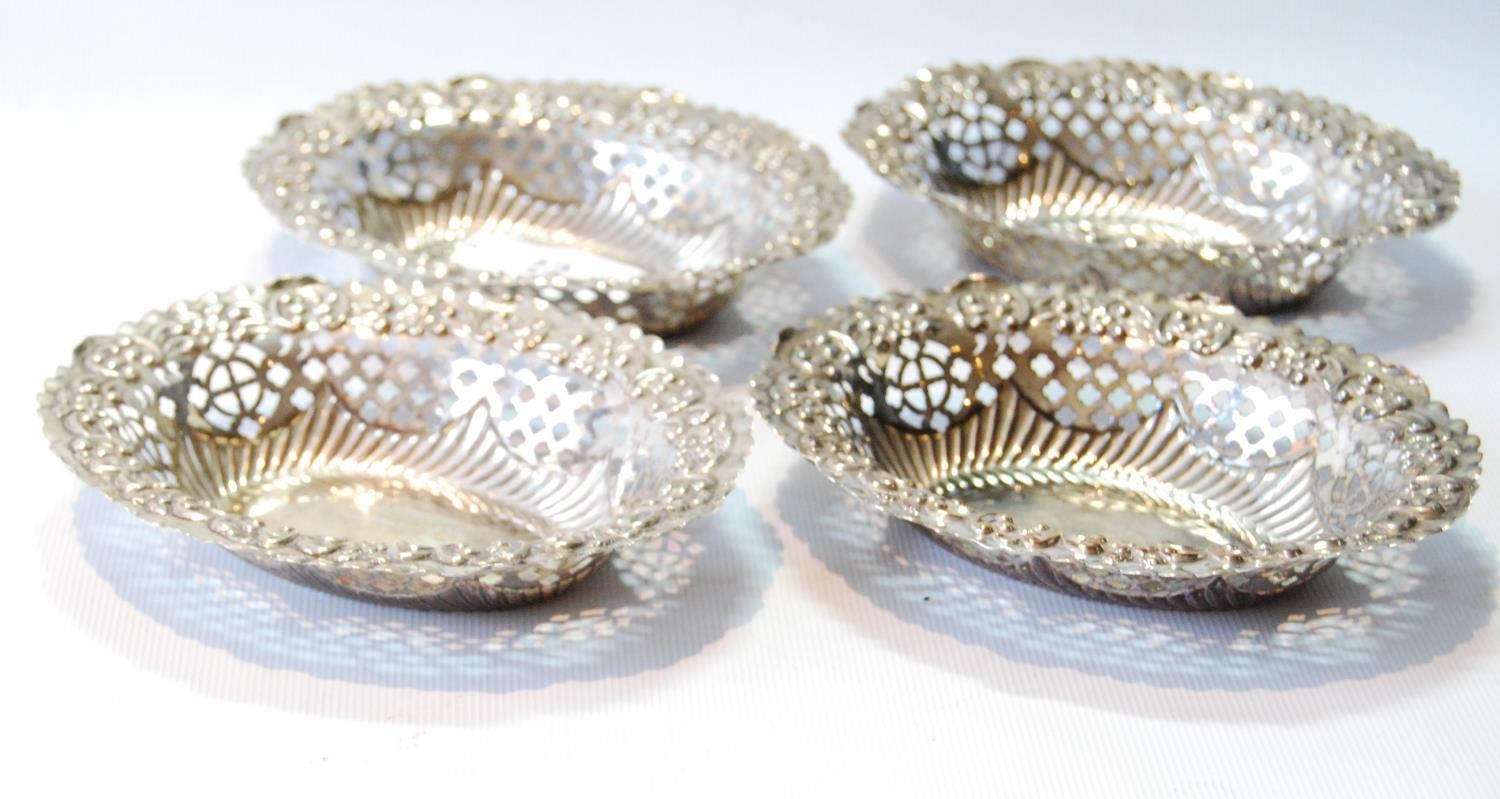 Set of four pierced and embossed oval silver sweetmeat dishes, by Hamilton & Inches, Edinburgh 1906,