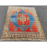 Turkish hand-knotted carpet decorated with assorted geometric medallions to the centre on a red