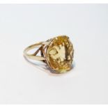 Ring with multi-faceted circular citrine, in 9ct gold, size O.