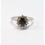 Diamond and sapphire oval cluster ring with small brilliants, in white gold, probably 18ct, size P.