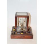 A General Post Office electrical instrument with central bulb housed in a mahogany case stamped GPO,