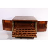 Mahogany table-top coin cabinet with fourteen pull-out tray drawers, 33cm wide.