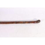Japanese carved hardwood walking stick with secret snuff spoon concealed to the top, 90cm long.