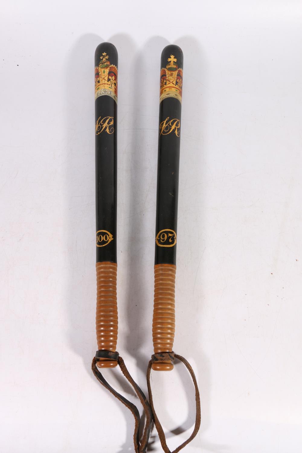 Two Victorian Scottish police truncheons, the black body with painted crowned VR cypher above the