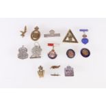 A collection of badges including a silver ARP (Air Raid Precaution) badge, To The Women of Australia