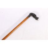 Walking stick with carved ebony hardwood handle in the form of a dog, the mouth with inset dog