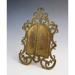 A Victorian gilt metal frame by 'Fisher, 1888 Strand', designed as a pair of central doors opening