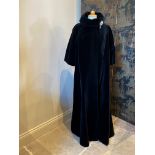 A black velvet cape, the floor length cape with single covered button fastening and large lapel