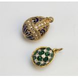 Two Faberge style egg pendants, both stamped '925', both paste set, 23mm and 28mm long overall (2)