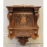 A carved oak wall bracket, 20th century, carved with a vacant shield and thistles, 55cm high