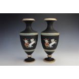 A pair of porcelain vases in the neoclassical style, 19th century, each black glazed pedestal vase