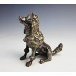 A silvered bronze poodle, modelled seated, 9cm high