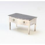 A George V novelty silver stamp box by A J Zimmerman, Birmingham 1923, modelled as a lowboy with