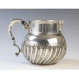 A George V silver jug, Elkington & Co, Birmingham 1923, of spherical form with scroll handle, the