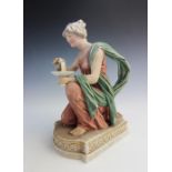 A Royal Dux figure of a water carrier, modelled kneeling, in pastel, gilt shot enamels and on plinth