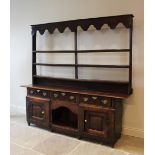 A mid 18th century and later oak dresser, the associated rectangular two plank top above three