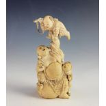 A Chinese ivory carving, 19th century, depicting a laughing buddha and two children, modelled as