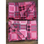 A pair of Welsh blankets, of traditional reversible geometric design in washed red, pink and