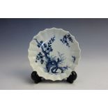 A Worcester saucer circa 1770, painted in blue with a prunus design, workman's mark in blue to base,