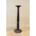 A 19th century mahogany torchere, the reeded and wrythen column raised upon a turned circular