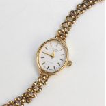 A Lady's 9ct gold Rotary wristwatch, the white oval dial with baton markers, set to a plain polished