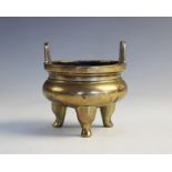 A Chinese Archaic bronze tripod censer, of compressed circular raised on three legs and with 'U'