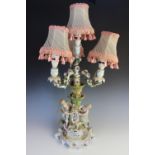 An Austrian porcelain figural table lamp, the base modelled as a young shepherd and shepherdess