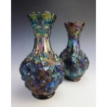 A pair of carnival glass vases, each of inverted baluster form with moulded continuous blackberry