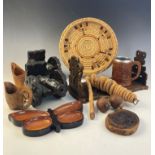 A collection of treen items to include; an oak book slide, a pair of model cannons, butterfly shaped