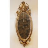 A 19th century French giltwood and gesso wall mirror, the oval mirrored plate within rope effect