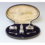 A cased George V three-piece silver cruet set by Adie Brothers, Birmingham 1921, comprising