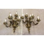 A pair of French rococo style gilt metal five branch wall light fittings, 20th century, the cast