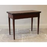 An early 19th century mahogany tea table, the rectangular folding top with a repeating flower head