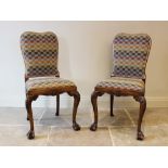 A pair of George II style walnut side chairs, early 20th century, the shaped padded back covered