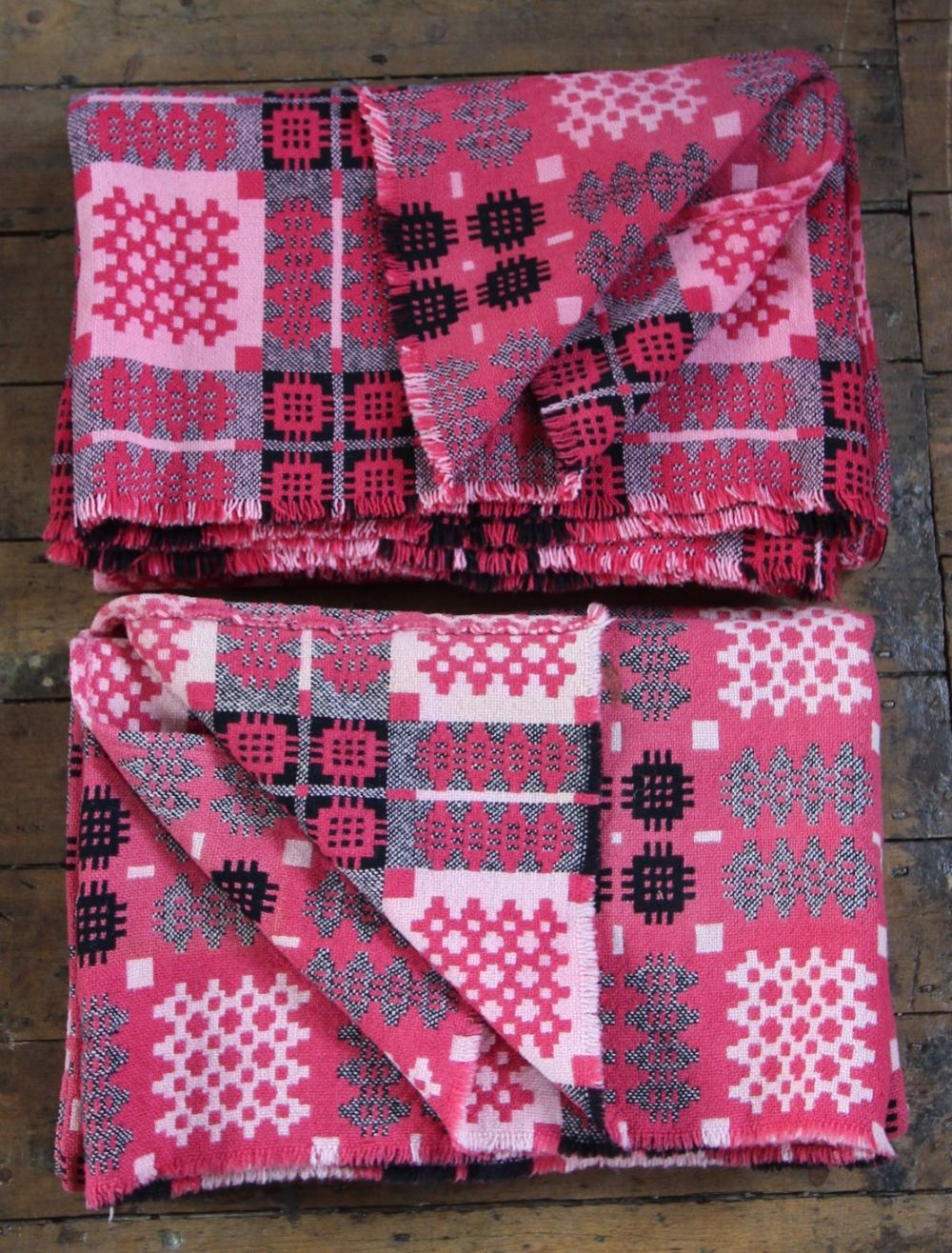 A pair of Welsh blankets, of traditional reversible geometric design in washed red, pink and - Image 2 of 4