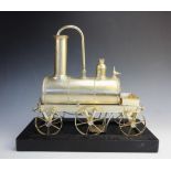 A white metal novelty coffee percolator, modelled as an early 19th century steam locomotive, with