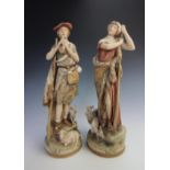 A pair of Royal Dux models of a Shepherd and Shepherdess, modelled with he playing a pipe besides