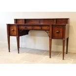 A Regency breakfront mahogany sideboard, the raised back with an open shelf over two central