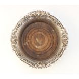 A silver mounted bottle coaster by C J Vander Ltd, Sheffield 1988, of circular form with shell and