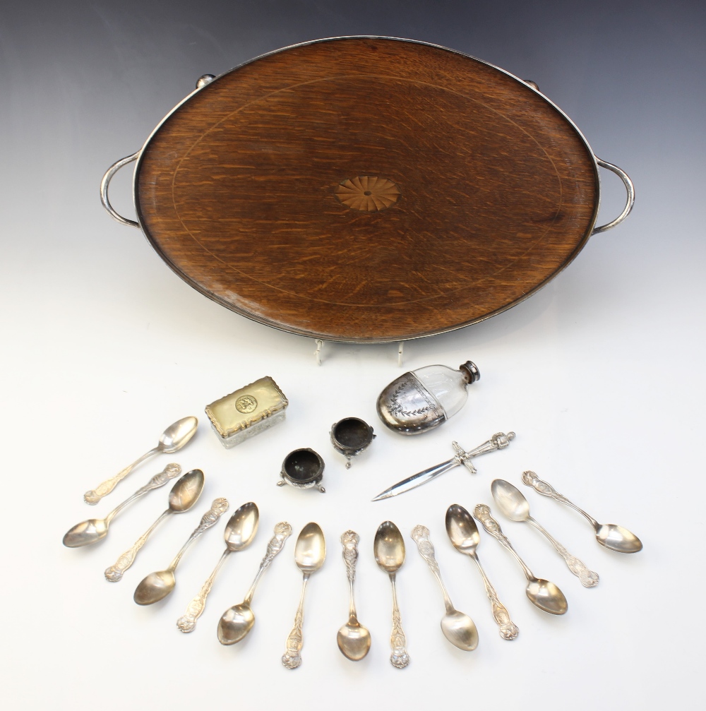 An oak inlaid white metal mounted twin-handled gallery tray, of oval form on four compressed ball