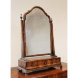 A George III style walnut Duchess dressing mirror, the arched shaped mirror plate above three frieze