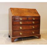 A George III oak and mahogany cross-banded bureau, the fall front with radiating geometric