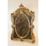 A Louis XVI style giltwood and composition wall mirror, 20th century, the rococo leaf scroll frame