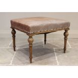 An early 20th century French walnut and leather dressing stool, the tan leather padded seat raised