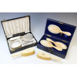 A cased set of carved ivory brushes and a mirror, each piece with intricately carved frieze of roses
