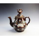A Victorian barge ware treacle glazed teapot and cover, late 19th century, the body with applied