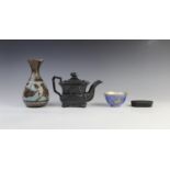 A black basalt teapot and cover, early 19th century, of waisted rectangular form, the body with