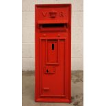 A Victorian wall mounted cast iron post box, the rectangular box cast in relief with the initials 'V